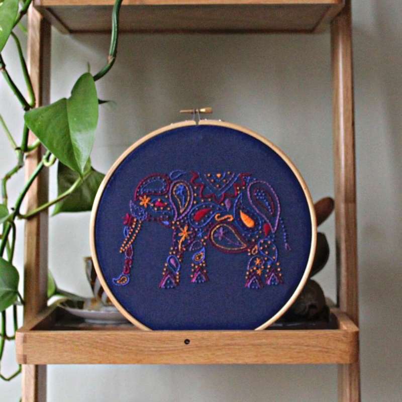 Purple, blue, red, lilac and orange elephant embroidery kit on shelf